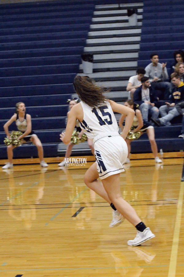 At the game against Shorewood, Hannah Carlson (18) makes her way down the court