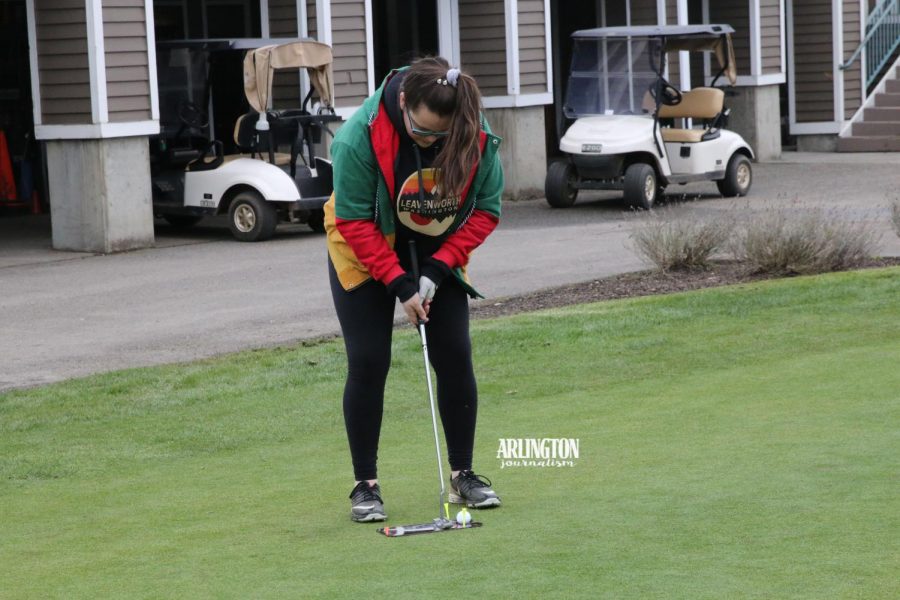 Cristina Hutchens ('19) practices on her putting skills at a practice leading up to the golf teams first match.