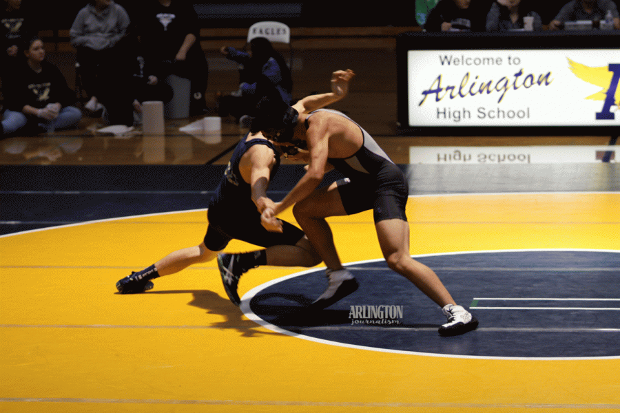 Karson Byle (20) goes for a single leg in his first match of the season against Kamiak.