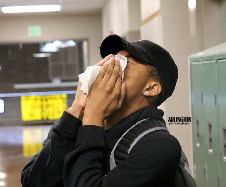 Justice Jackson (18) covers his sneeze with a tissue in the C wing hallway. Justice lives with allergies everyday but it worsens in the Spring. He uses a variety of methods to relieve his allergies. 