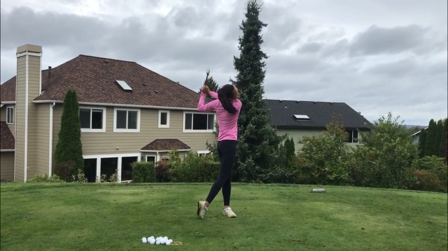 Mailinh Vu demonstrates her swing as part of her recruiting video to send to colleges. She is focusing on holding a sleek yet powerful swing to show her potential as a collegiate athlete. 