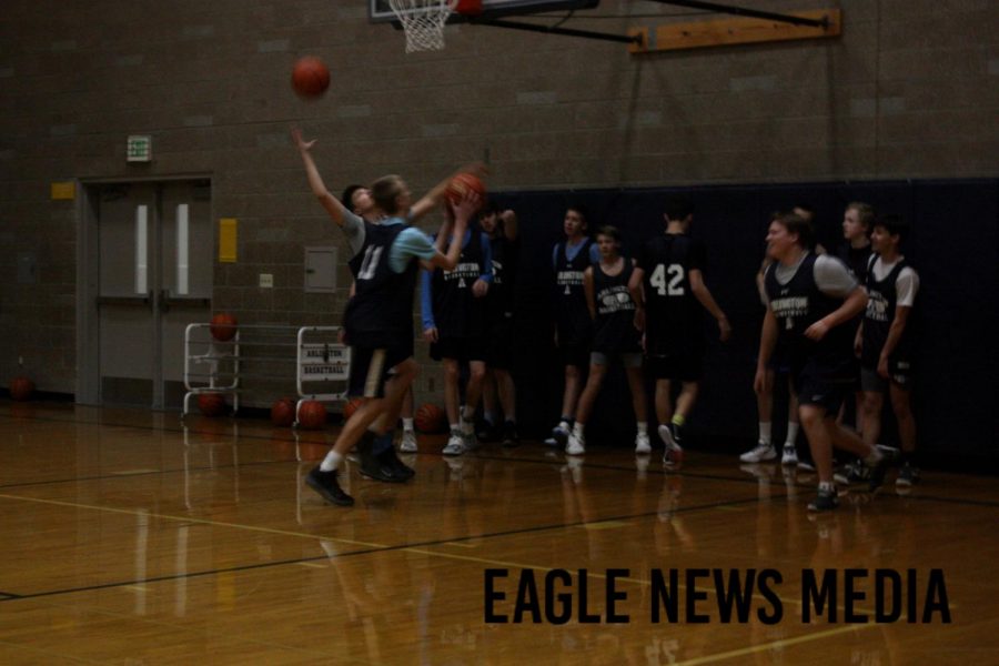 The C team boys basketball team practices  after school, by scrimmaging each other.