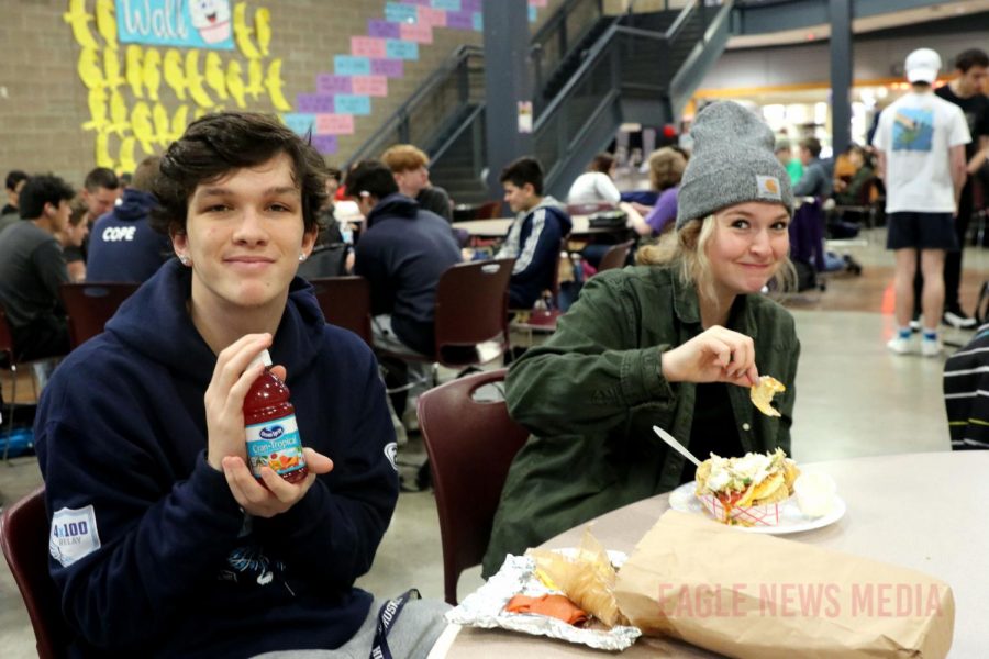 Seniors Chase Peterson and Ashley Contonio eat during first lunch on nacho Friday. 