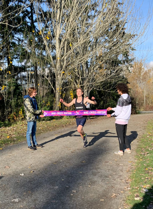 Vincent Loftis runs through the finishing tape at Magnuson Park in Seattle for the 2020 Nike Virtual Nationals. Loftis broke the school record with a time of 15:13:9.