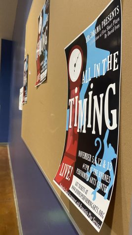 A picture of a poster promoting the AHS Fall Drama production “All in the Timing” in the hallway. Taken 11/04.