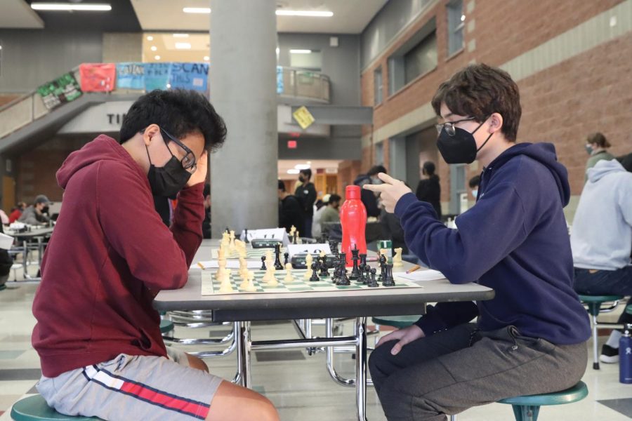 Two Students are seen playing chess during chess club on Feb. 10. The one in red is Ralph Pardillo (25)