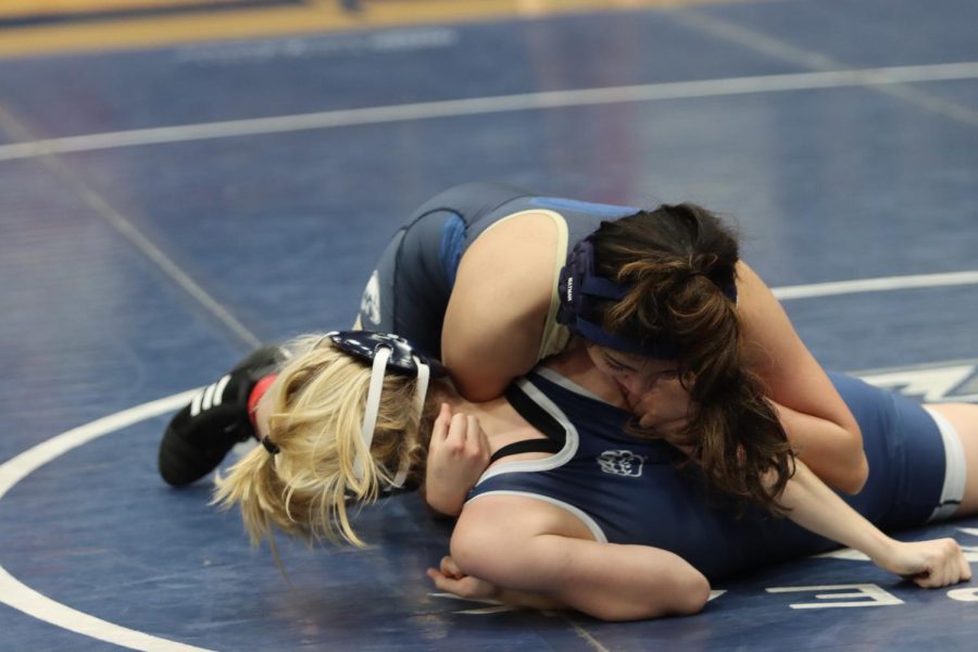 A member of the AHS girls wrestling team pins her opponent during her match on Jan. 11. 