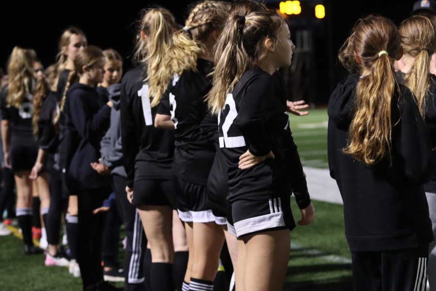 Members of the AHS Varsity Girls Soccer team line up before a match. 