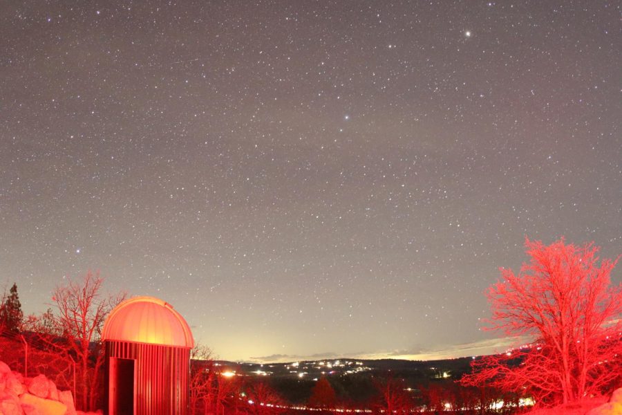 An image facing west from the Goldendale Observatory. On the left is the old observatory. Light from the building caused the red shift in the image. 