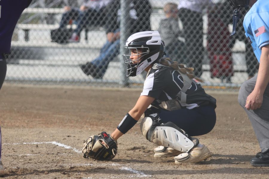 A member of the varsity girls softball team is seen playing on March 28, 2022. 