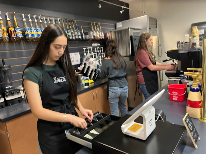 Kamila Estrada, Jayden Gonzales, and Meredith Marsh tend the Student Stores bar