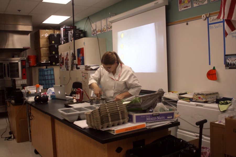 Ms. Bravo demonstrates the baking project her first period culinary class is working on at the end of the semester. 