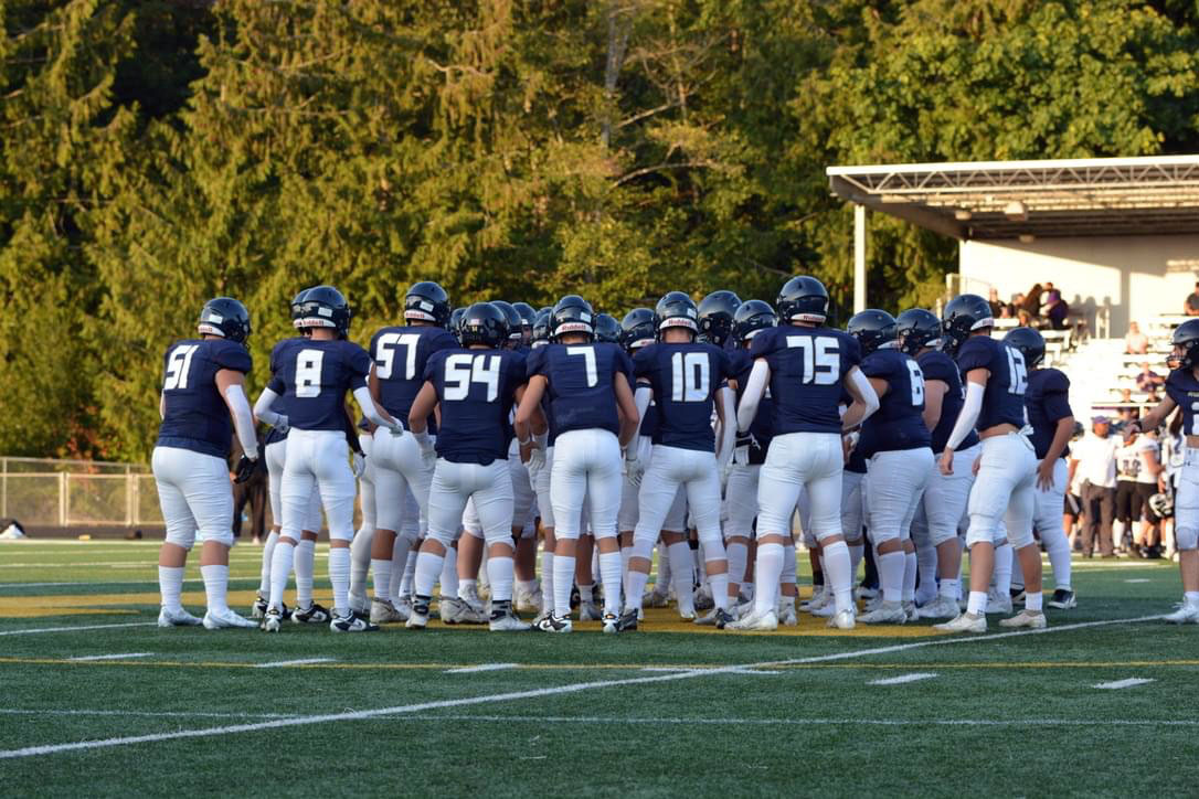 The varsity team gathers together on the field at the Kamiak game on September 1.  Eagles won 46-8.