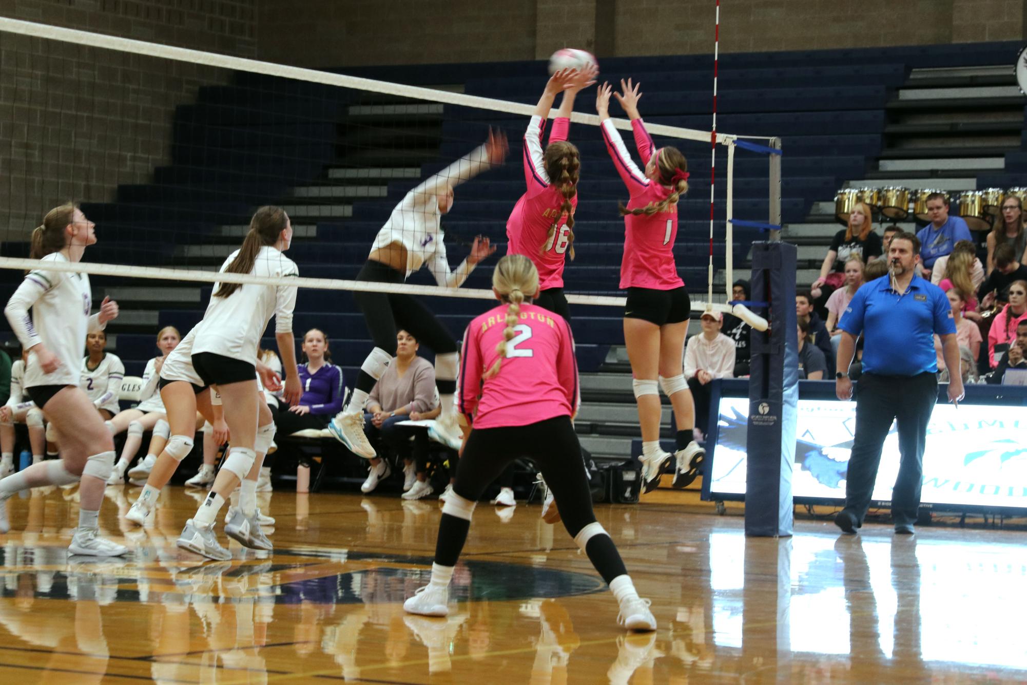 At the net blocking a hit is Emma Armes (‘24) and Sophie Graham (‘25) during the game on  October 17.  Arlington beat Edmonds-Woodway 3-0.Sophie and I both went up to block the hitter while Delanie Theuret is covering in case of the ball hitting off our hands said Armes.