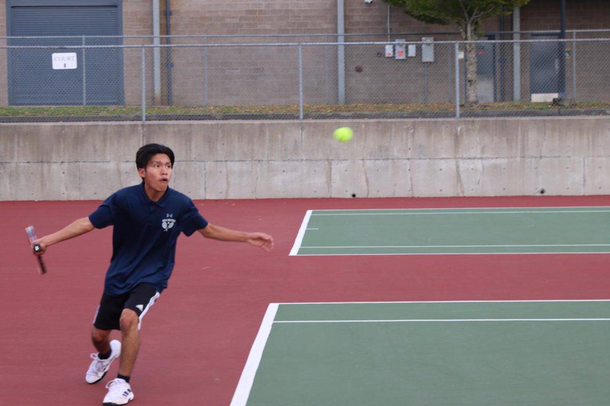 Irving Gonzalez-Toribio (25),  is preparing for his match by warming up with whats called a “stroke” in tennis. He had joined this team because he had just wanted something to do after school. Tennis to him is “going out and having fun no matter what the score is.” 

