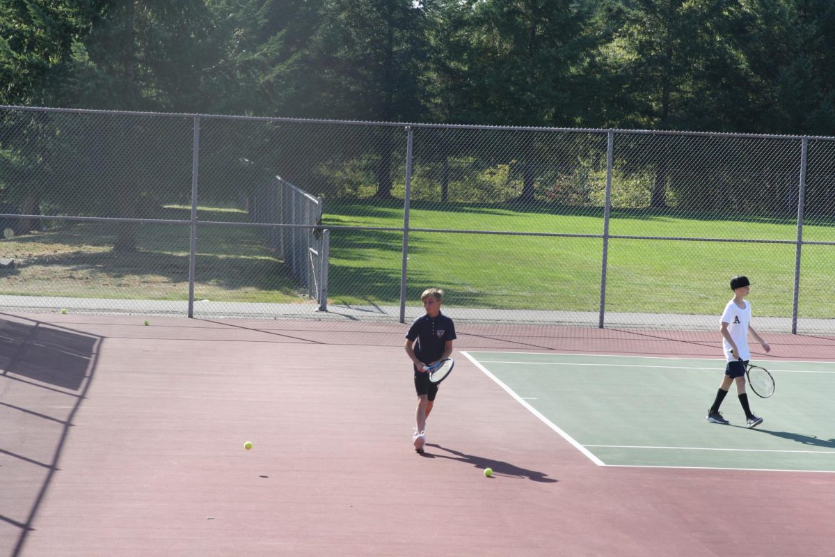 In practice on September 21, Eli Hoover (27) is picking up tennis balls. He said the season went alright with a record of 6-6. He will play next year in hopes of lettering. 
