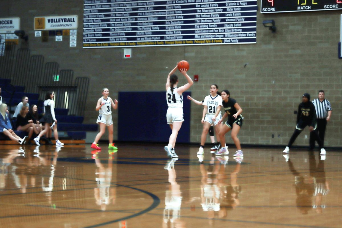 Looking for her team to move in the right formation Jazzlyn Berns (‘26) is holding the ball over her head in a ready stance. The players on standby during this play was Savannah Thomas (‘26) and Kai Jannsen (‘27). “I’m dumping it to Savannah at the post,” said Berns. 
