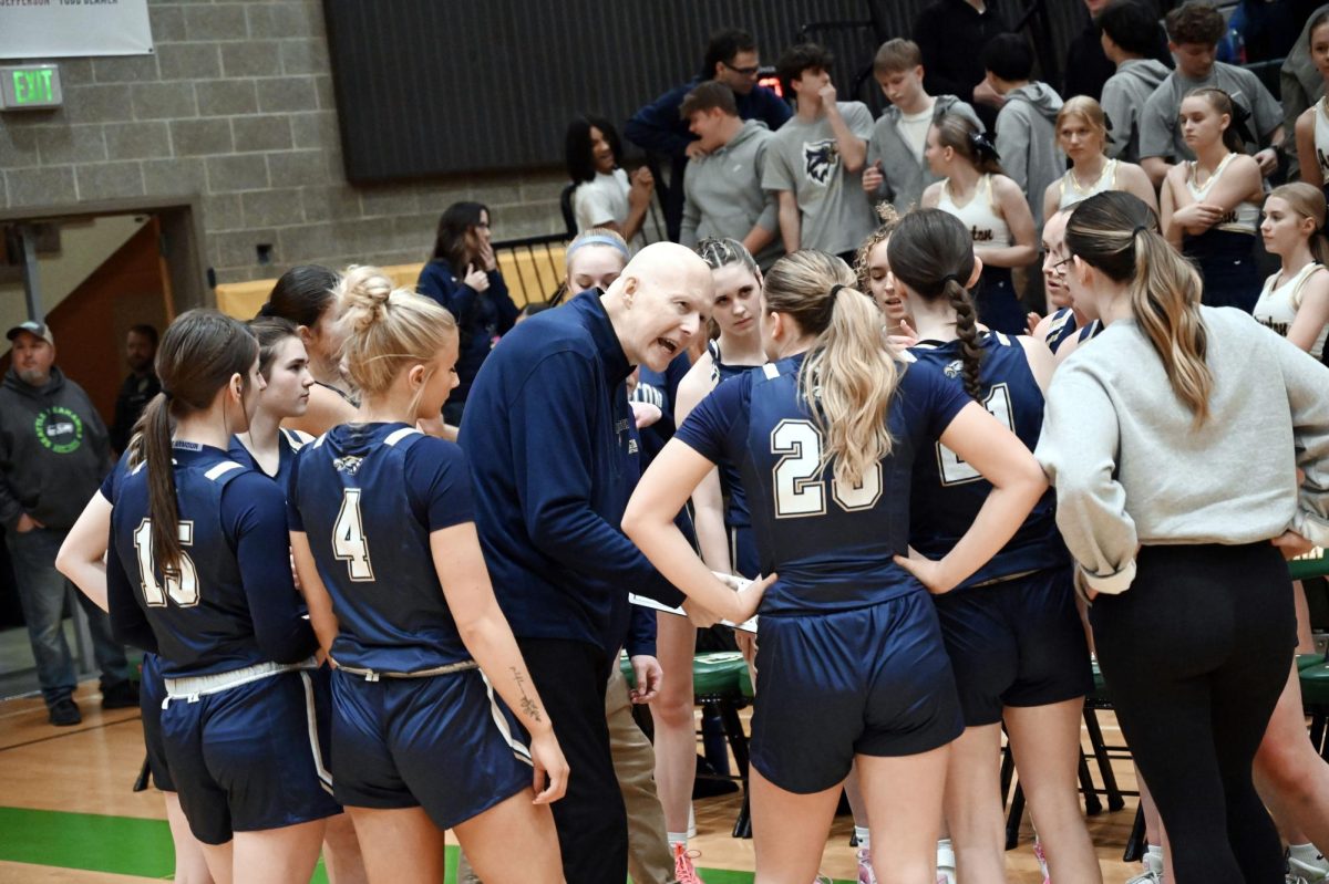 Jersey walker (25’) Taelor Kron (24‘) Tatum Carbajal (25‘) and the rest of the girls varsity Eagles huddle together to take orders from the coach in order to win the extremely closely-matched game against the Auburn Trojans.