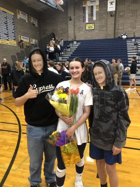 Savannah Roberts celebrates senior night to end four years of high school volleyball.  Her cousin and brother had fatheads for the evening. 