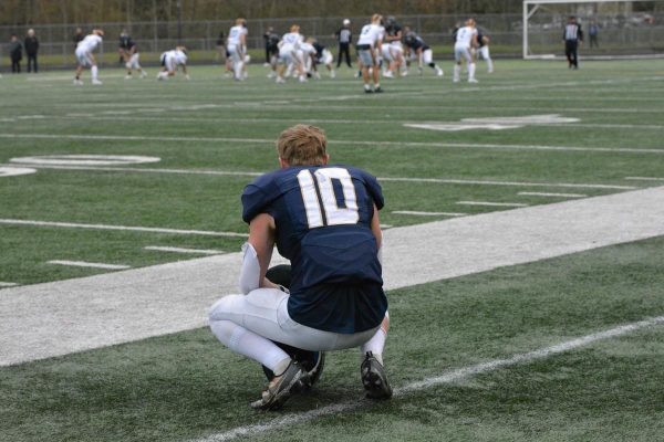 Senior Caiden Patterson crouches down and tries to process the stress that continues to grow, and how he will be able to deal with it, throughout the only loss of the season for the Arlington Eagles Football Team.