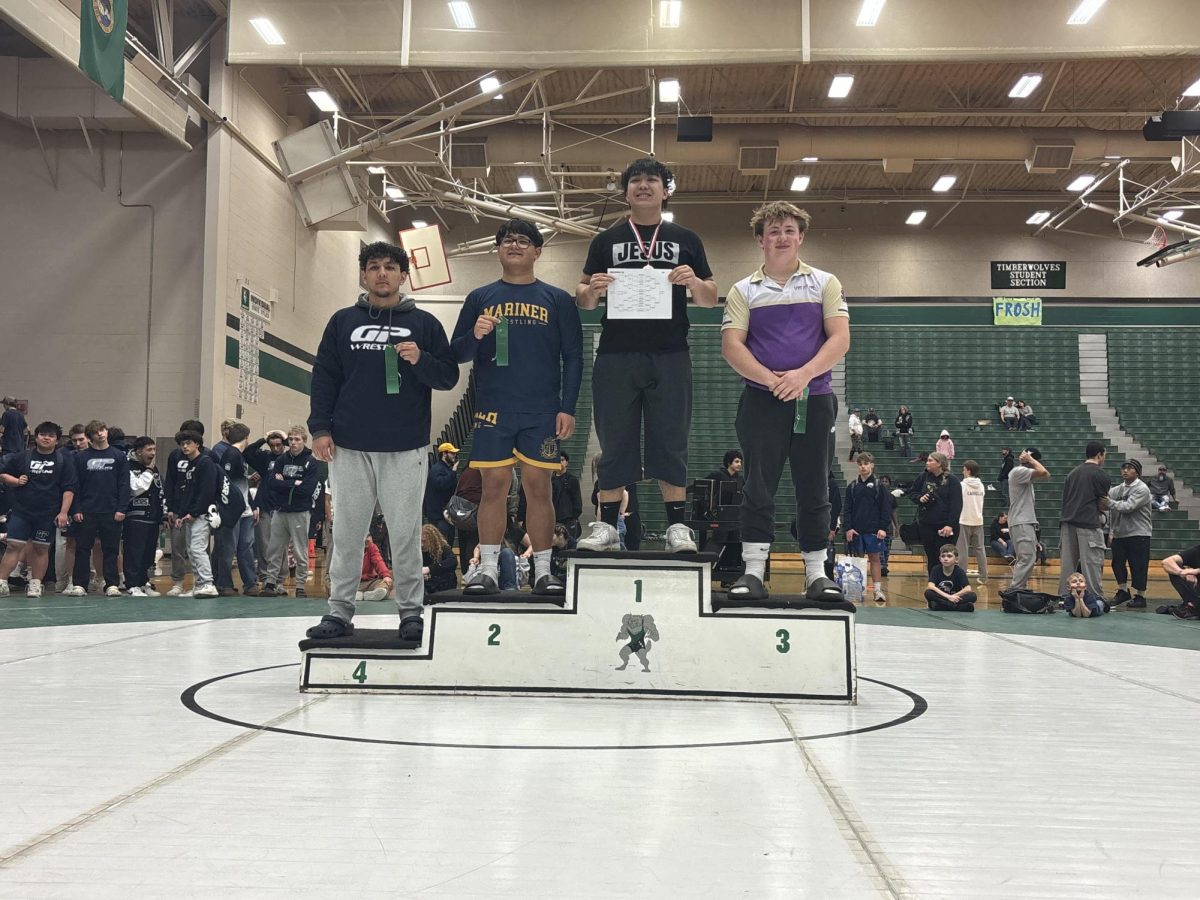 Roderick Bernardo (12) standing on the podium at Jackson High School after taking first place in the 215 weight class during the WIAA district one tournament. Bernardo has been wrestling all throughout high school and is very happy with this win, and thanks his coaches for helping him succeed. “The coaches are a blessing. They always make sure to push us to our limits, and even past that. Always listen to your coaches because they know what's best for you,” said Bernardo.
