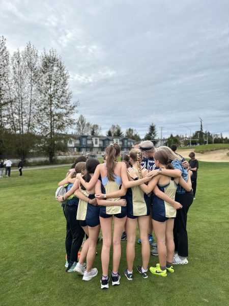 Girls Cross Country team coming together after a race.