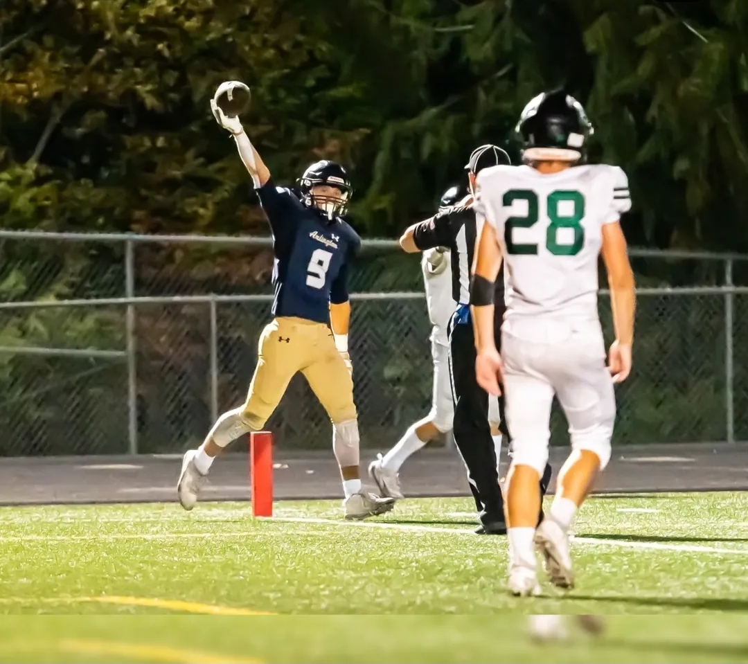 Dylan Durfee ('26) scores a touchdown on a sliding grab, and shows the referee the ball.