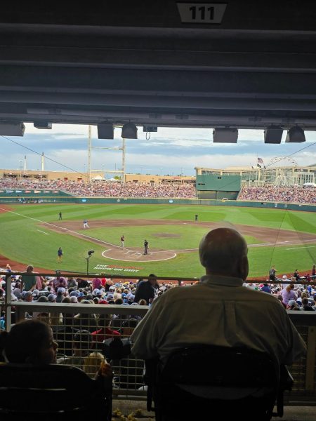 A baseball game being played, and a wide shot from behind the plate.