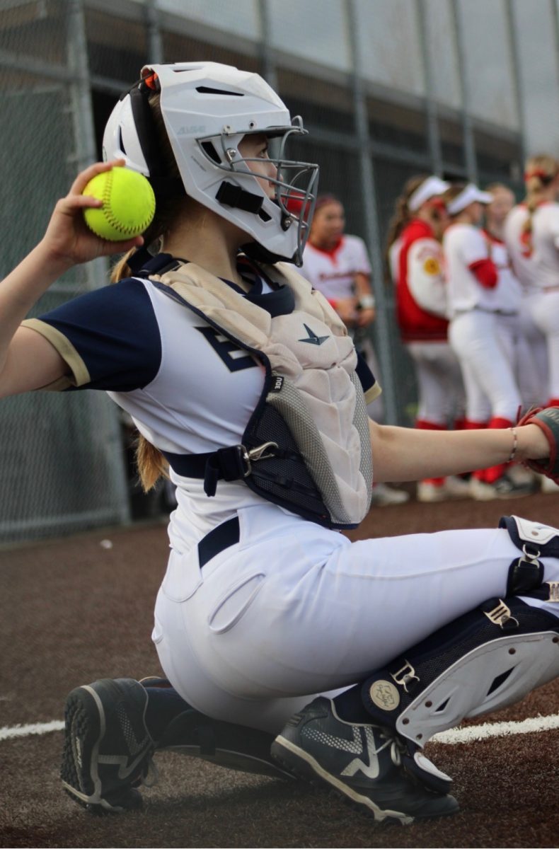 This is Ella Smith on the Varsity team catching for the Arlington Eagles game. 