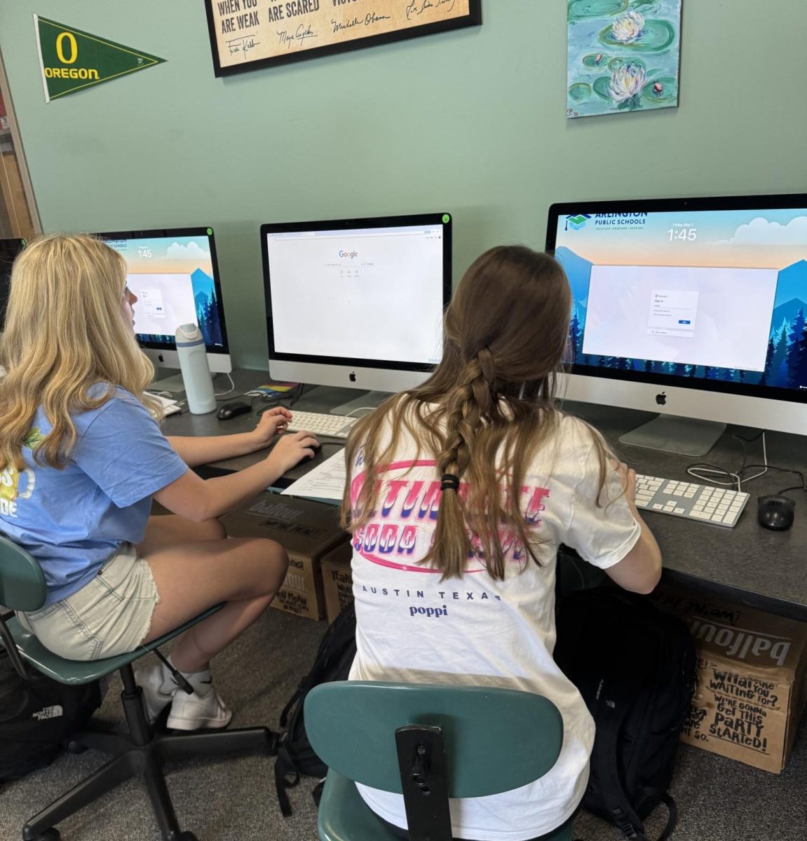 Two girls working on the computer in class.