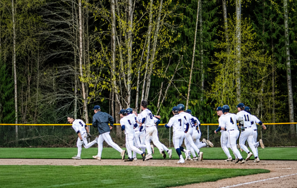Players running after their teammate after a walk off win at Arlington High school. (AI was used for picture adjustments)